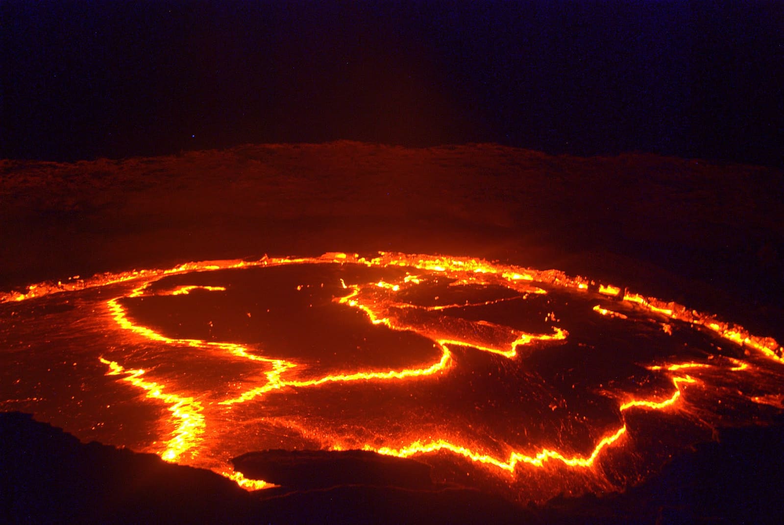 The glowing surface of the Erta Ale lava lake at night