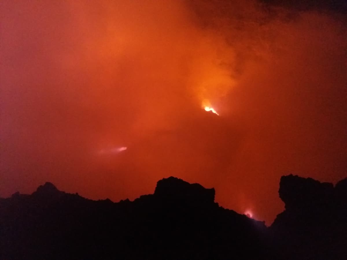 The red glow of the Erta Ale crater lighting the night sky