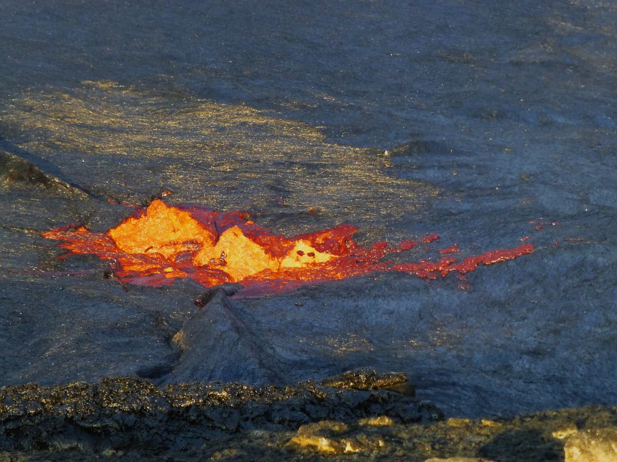 Molten orange lava cracking through the black crust of the Erta Ale lava lake