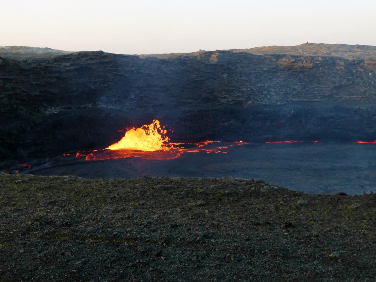 A fountain of molten lava bursting through the crust of the Erta Ale lava lake